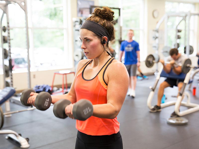 A female student works out in the weight room